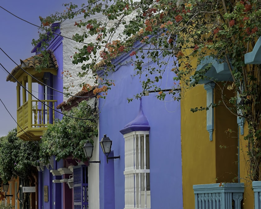 Brightly painted blue and orange colonial balconies on a Cartagena street, Colombia
