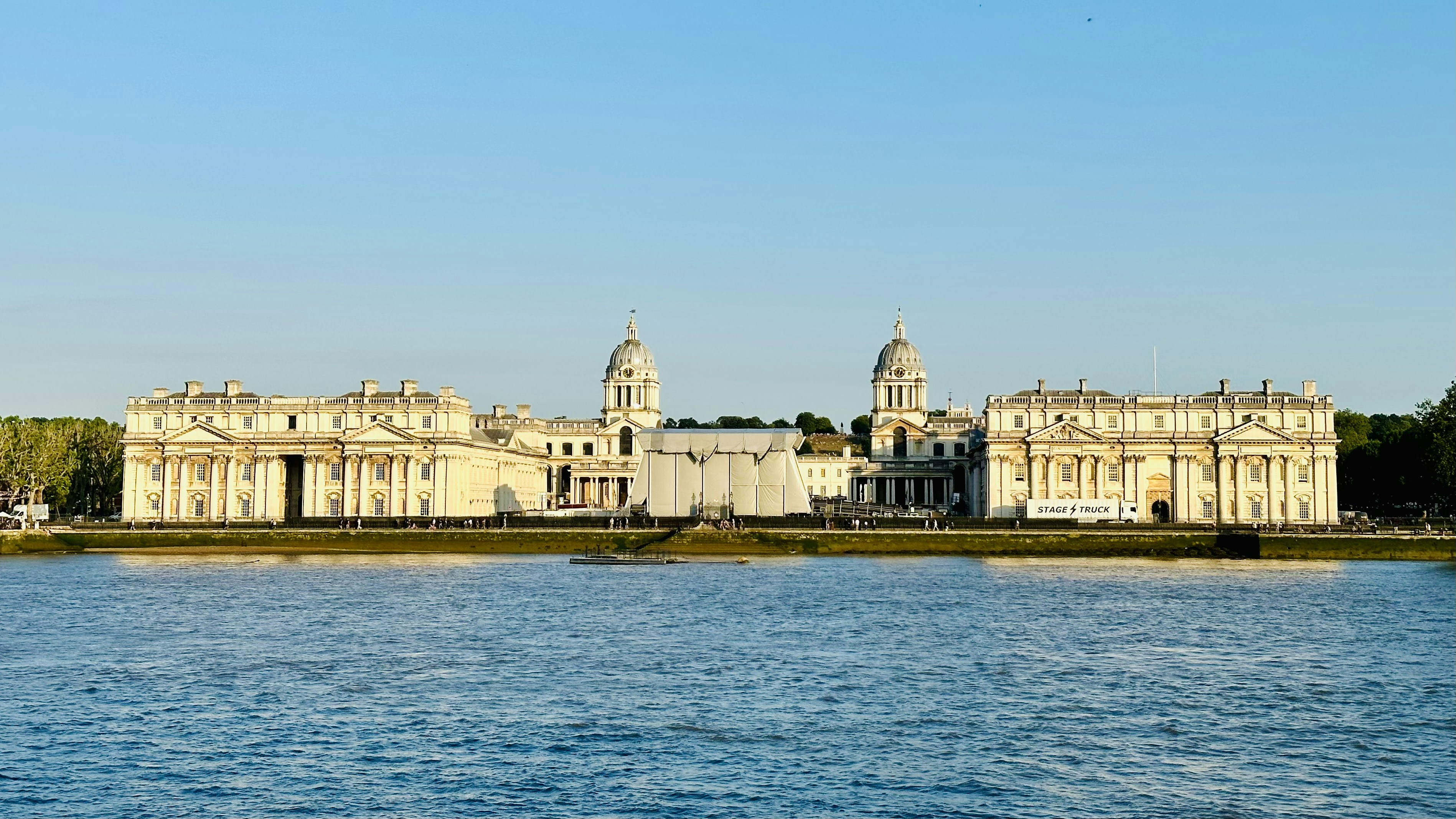 a large white building sitting on top of a lake
