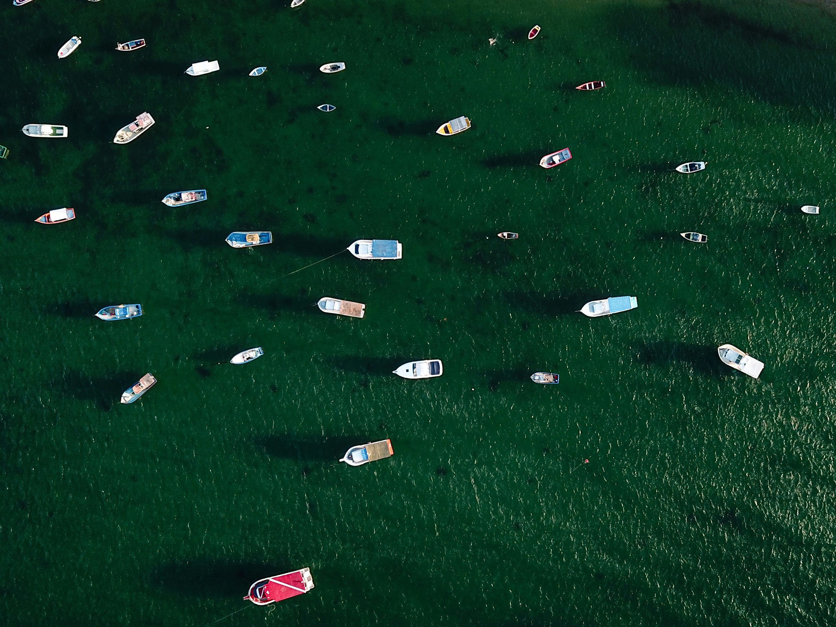 a group of boats floating on top of a body of water