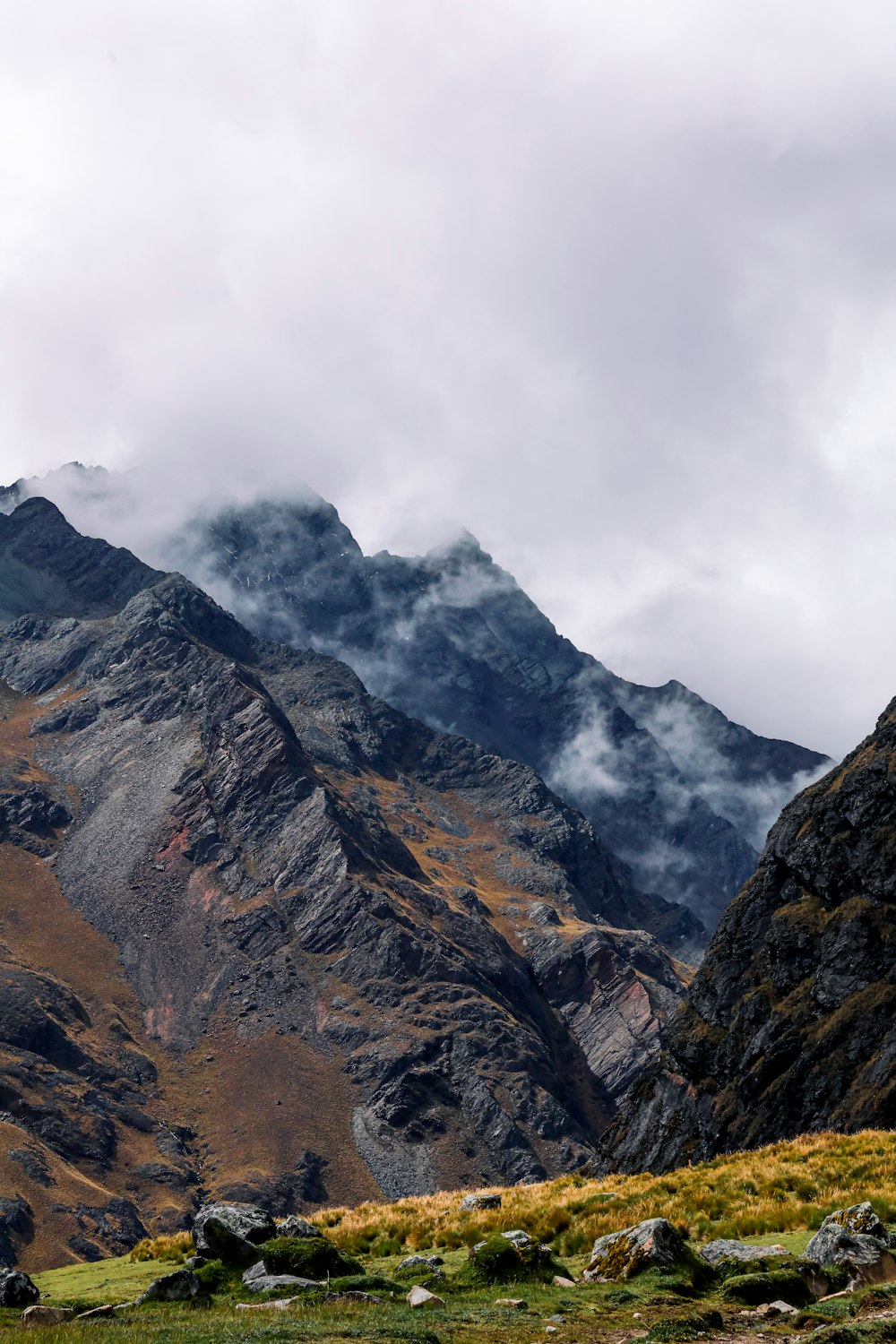 a mountain range with a few clouds in the sky