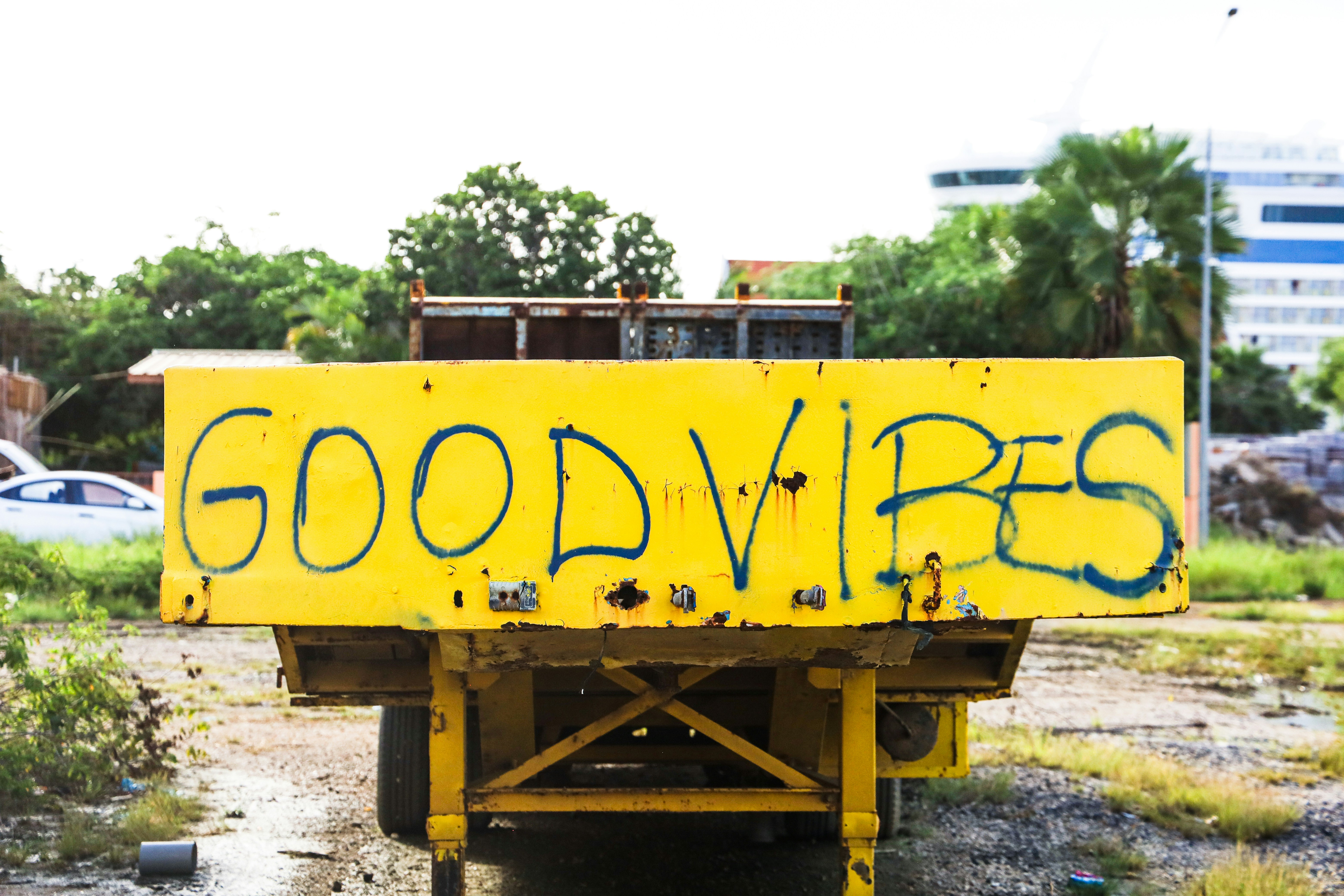a yellow sign that says good vibes on it