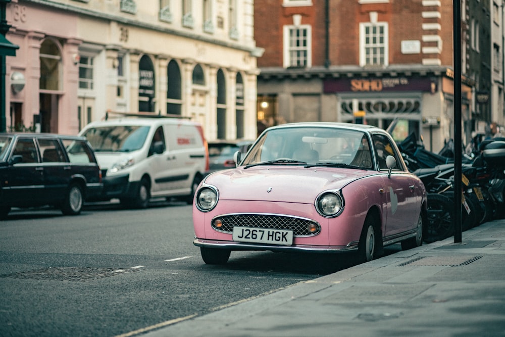 a pink car parked on the side of the road