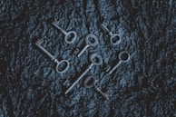 A close-up of antique keys and handwritten letters on a wooden table, hinting at the mysteries to uncover.