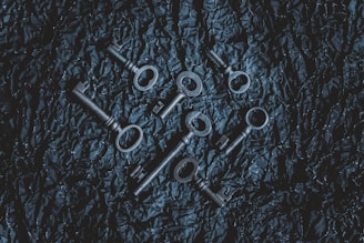 A close-up of antique keys and handwritten letters on a wooden table, hinting at the mysteries to uncover.