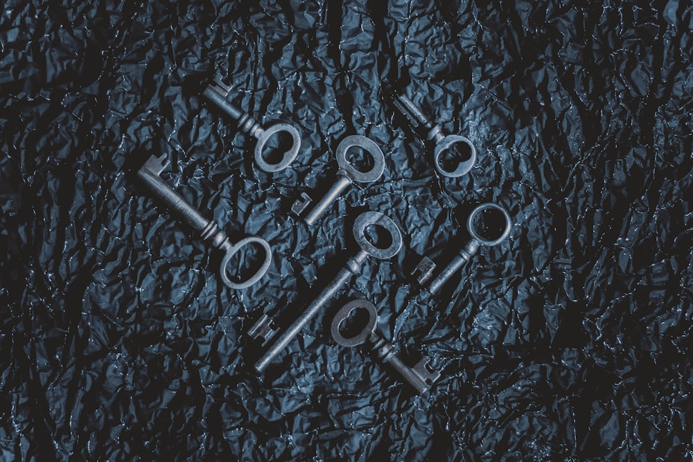 a group of metal keys sitting on top of a table