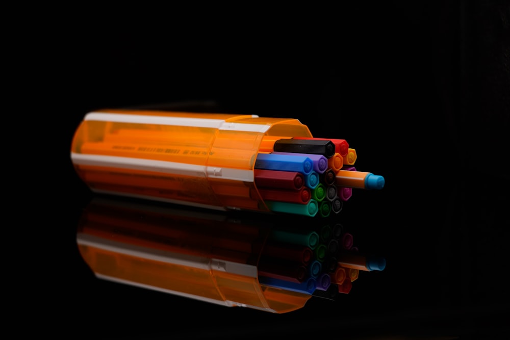 a group of colored pencils sitting on top of a table