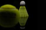 Close-up of a shuttlecock mid-air during an intense rally.