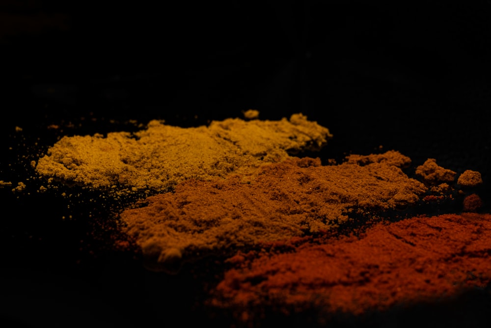 a bunch of different colored powders on a table