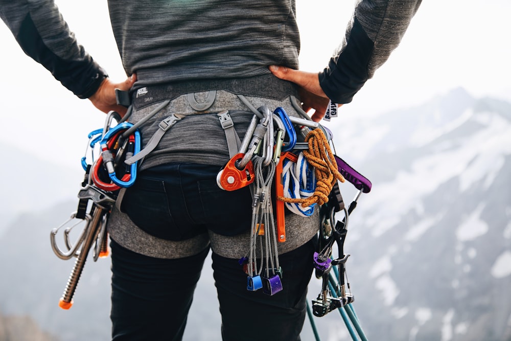 a person holding a bunch of skis on their back