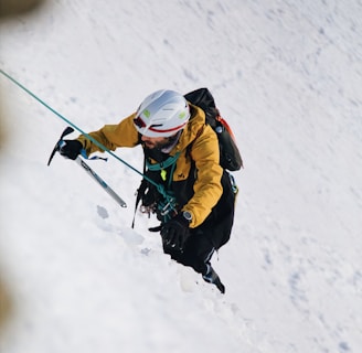 a person on skis going down a snowy hill