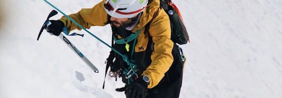 a person on skis going down a snowy hill