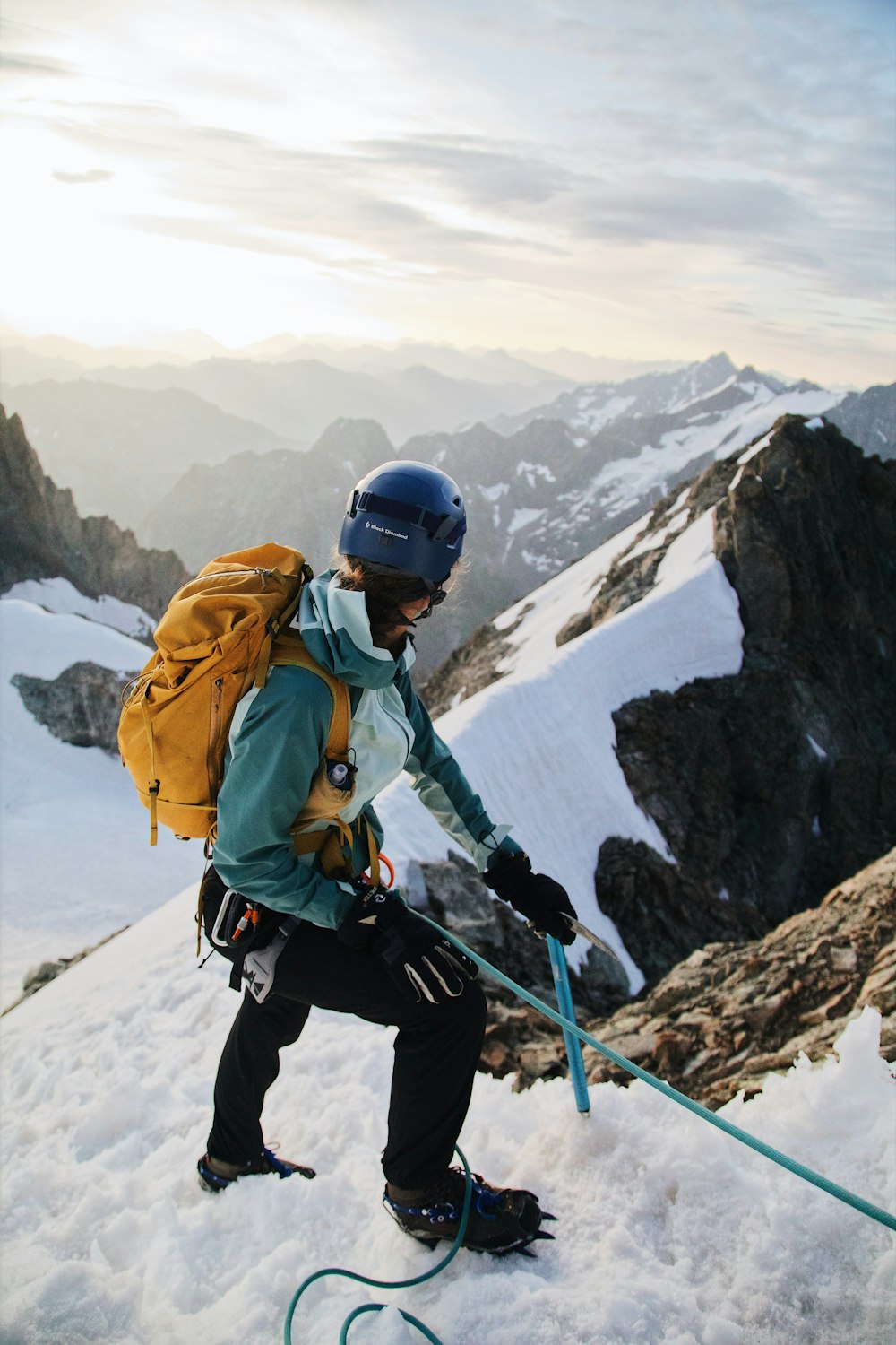 a person with a backpack and skis on a snowy mountain