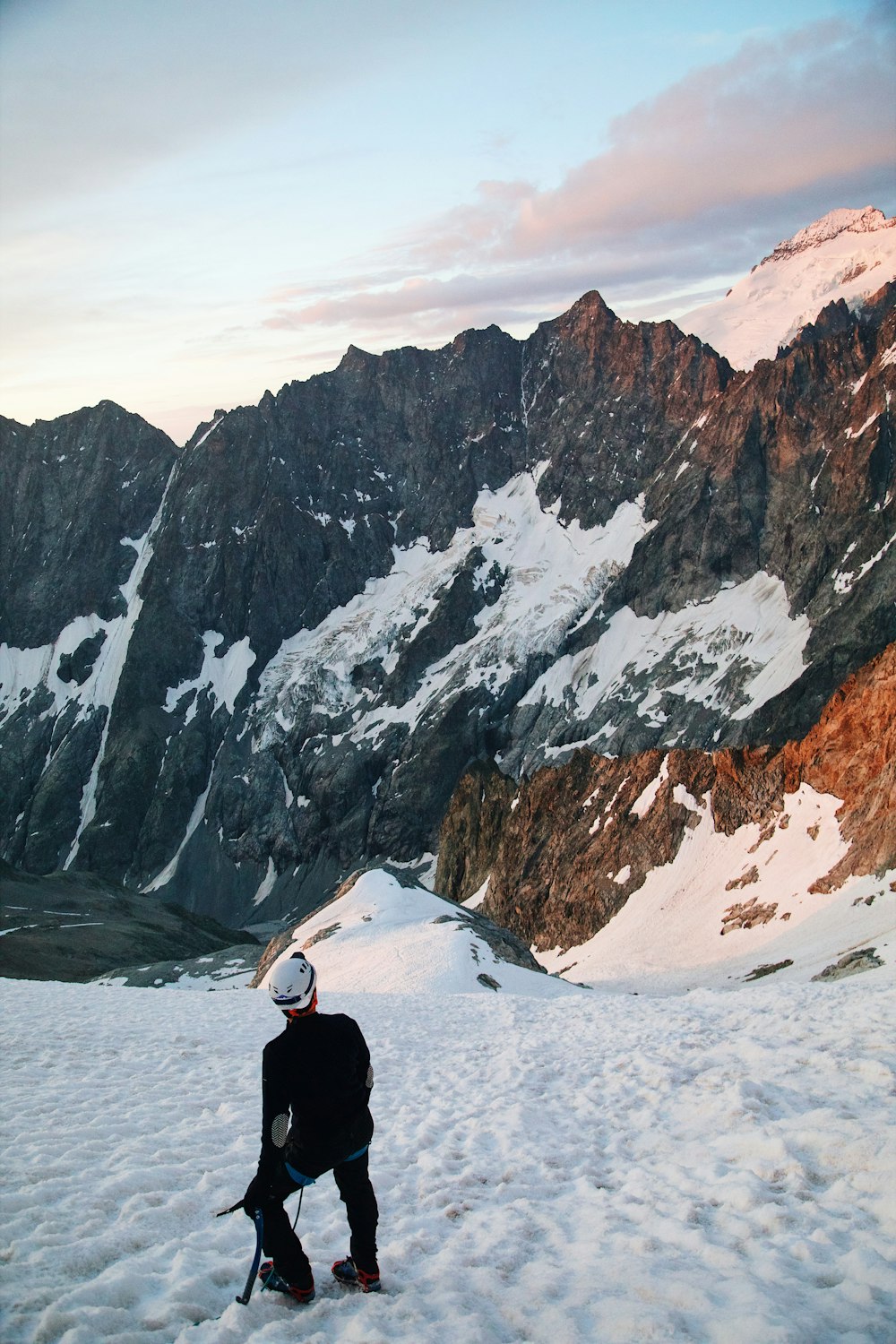 a man standing on top of a snow covered slope