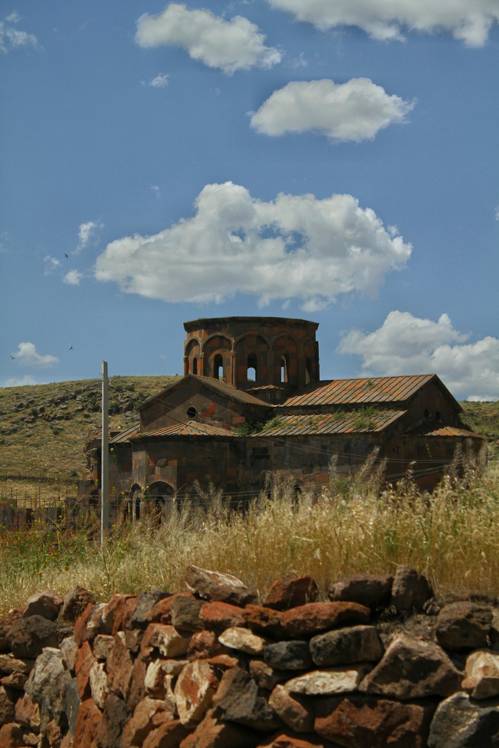 a large building sitting on top of a lush green field