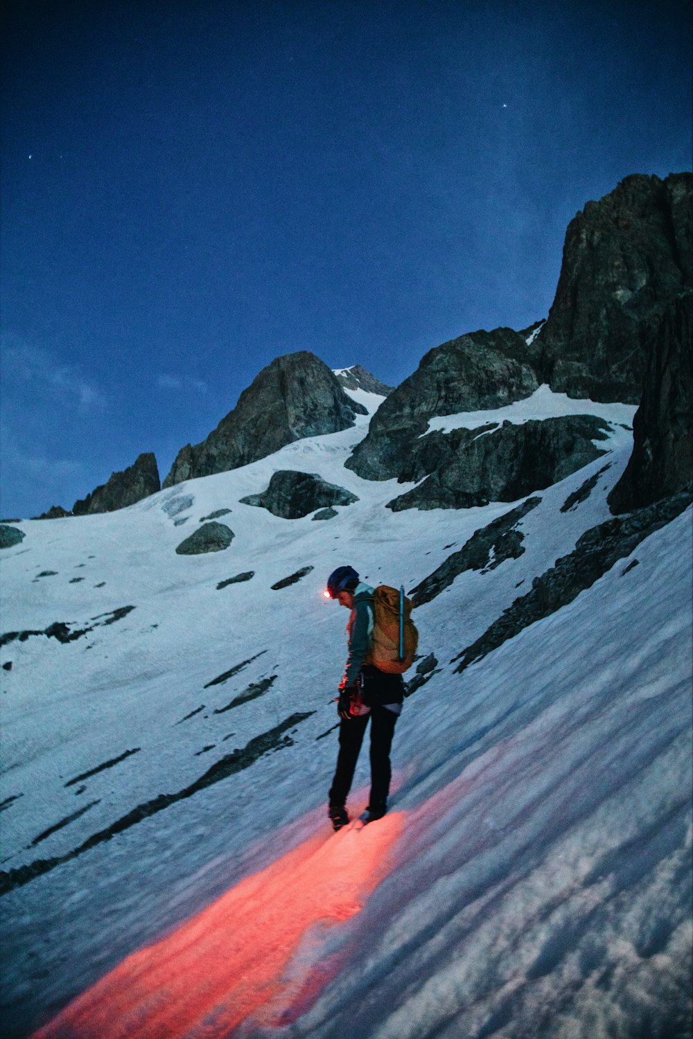 a man standing on top of a snow covered slope