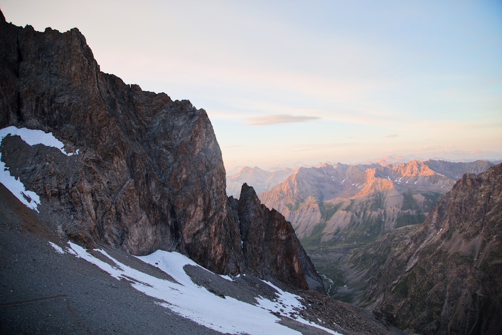 a view of a mountain range with snow on the ground