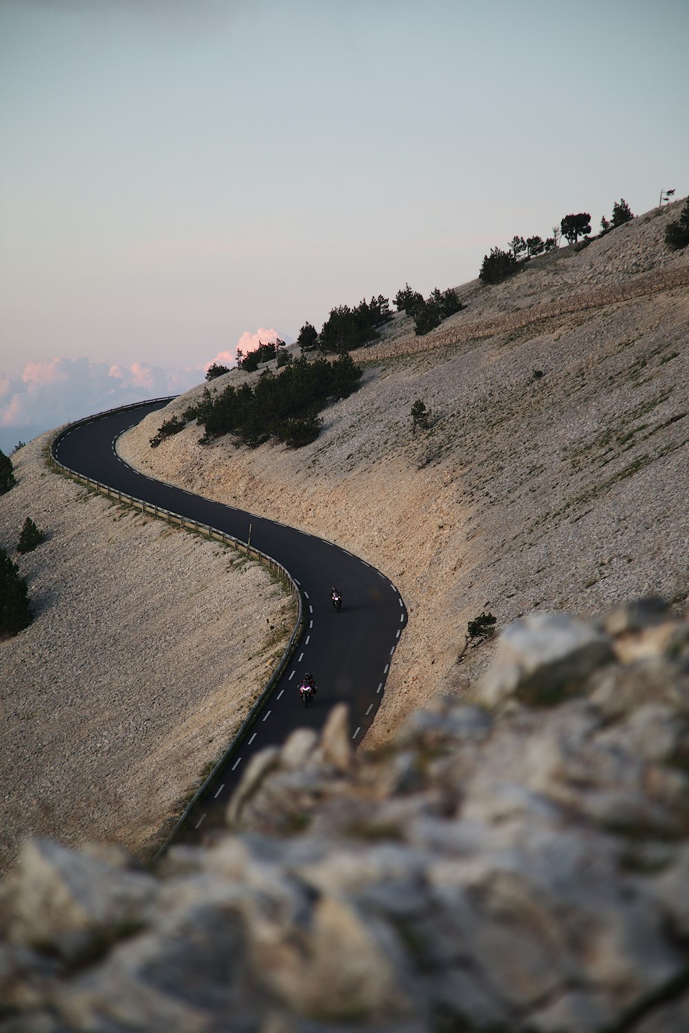 a car driving down a winding road in the mountains