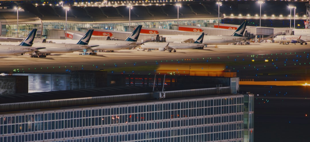 a row of airplanes parked at an airport,