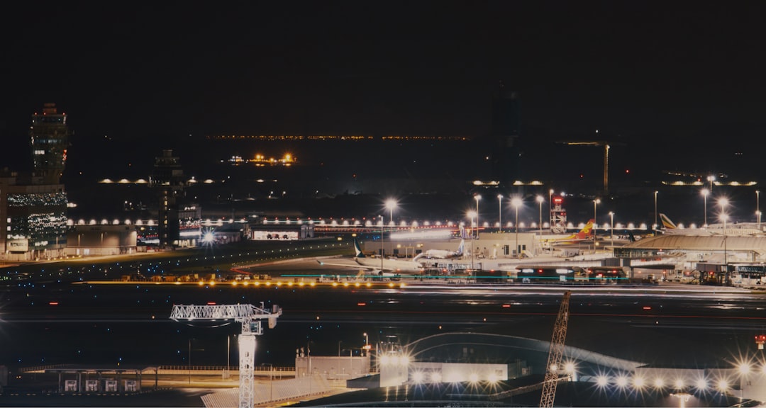 an airport at night with lights on the runway,