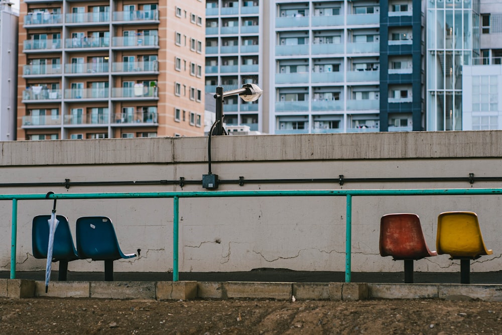 a row of urinals sitting next to a cement wall