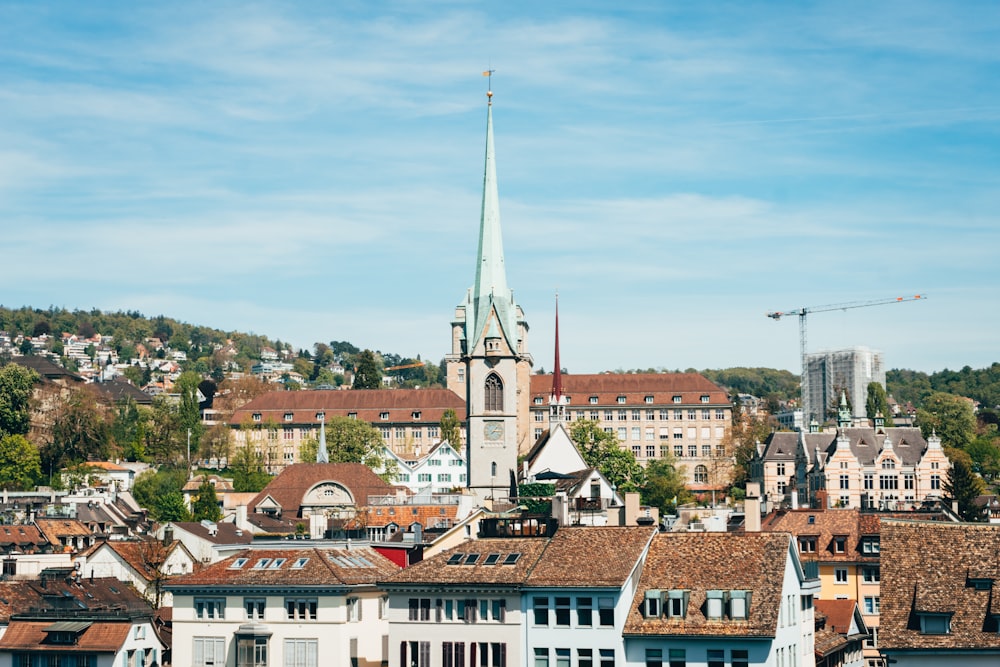 a view of a city with a steeple in the background