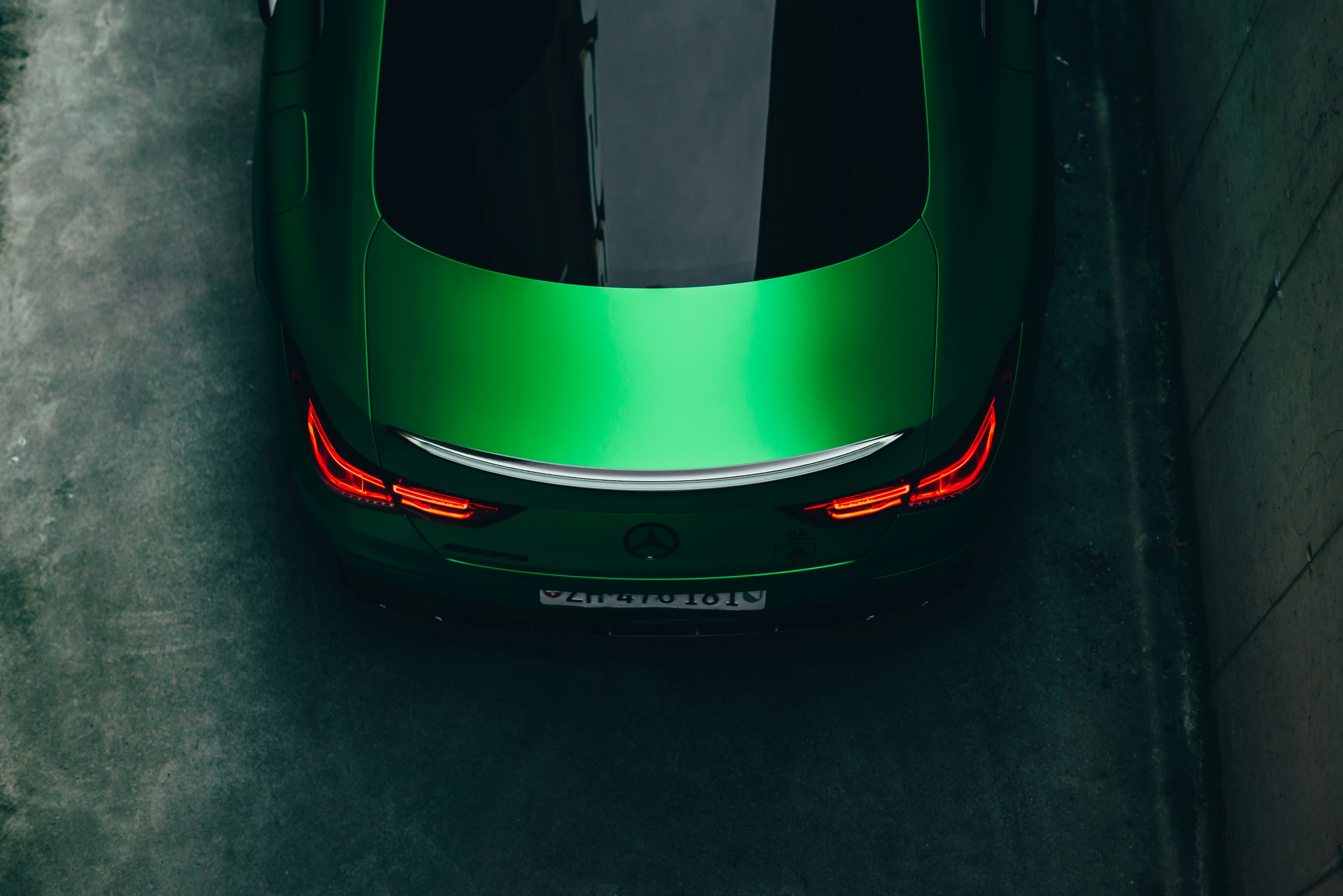 a green sports car parked in a parking lot