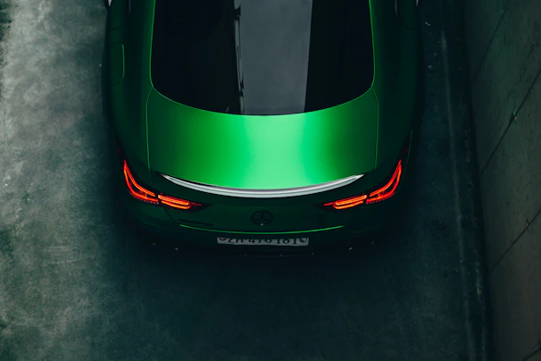 a green sports car parked in a parking lot