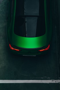 a green sports car parked in a parking lot