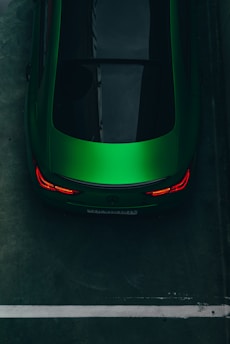 a green sports car parked in a parking lot