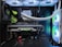 A high-end gaming or performance PC interior equipped with RGB lighting and multiple cooling fans. The graphics card prominently displayed is a GeForce RTX model, with branding visible. The setup includes neatly managed cables and a liquid cooling system.