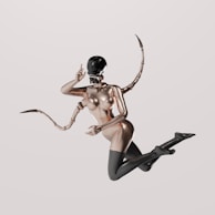 A metallic humanoid figure with smooth, reflective surfaces is posed in a dynamic stance. It features insect-like appendages protruding from its back, adding an otherworldly or futuristic element. The head is covered with a glossy, featureless helmet.