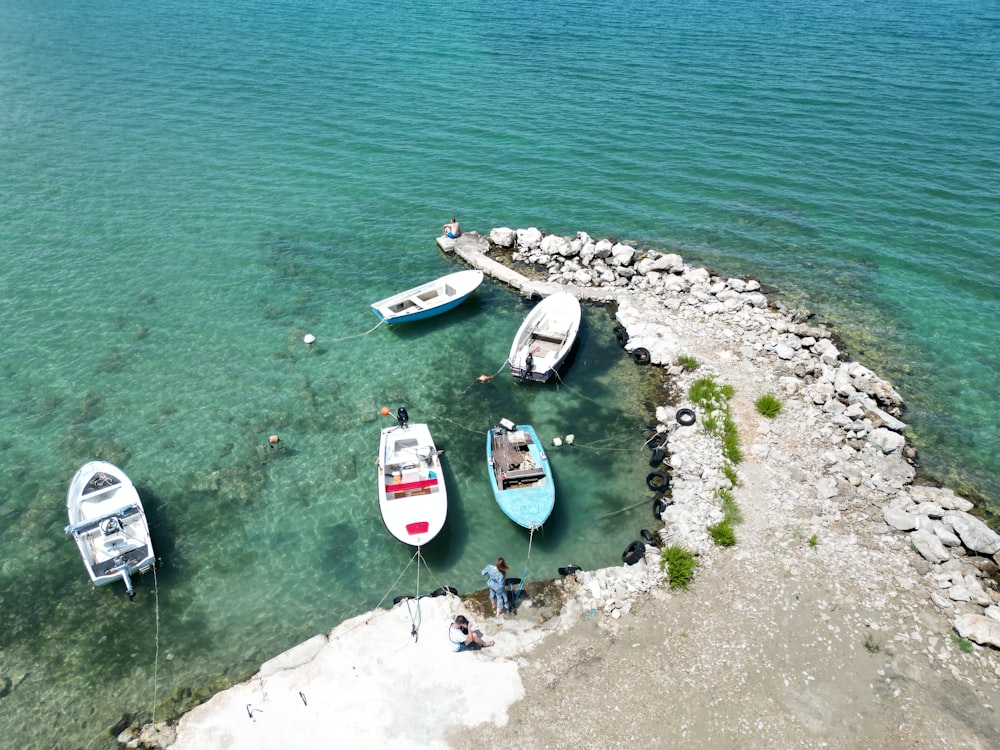 a group of boats floating on top of a body of water