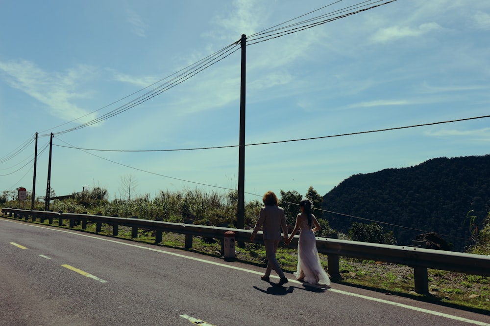 a man and a woman walking down a road