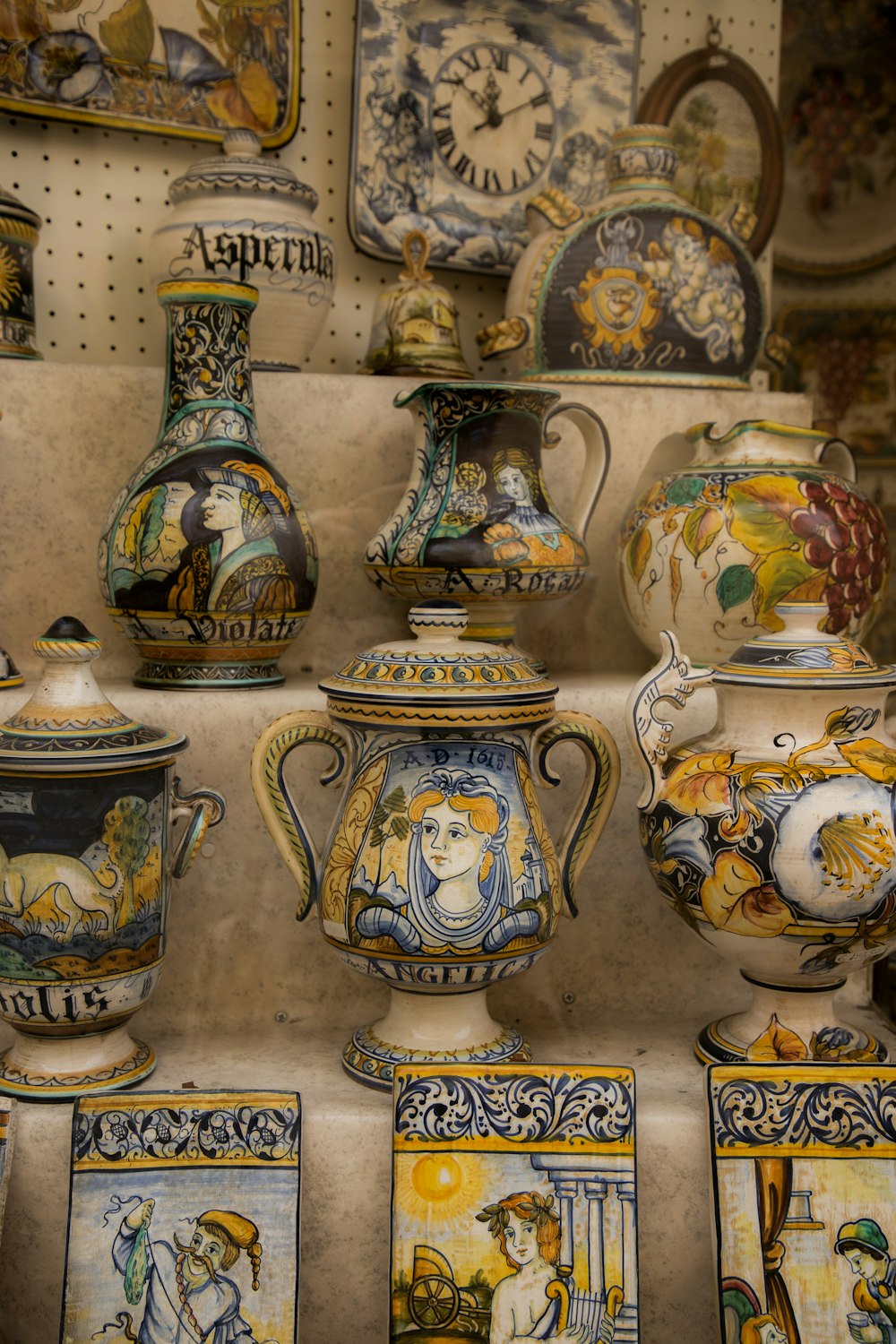 a bunch of vases that are on a shelf