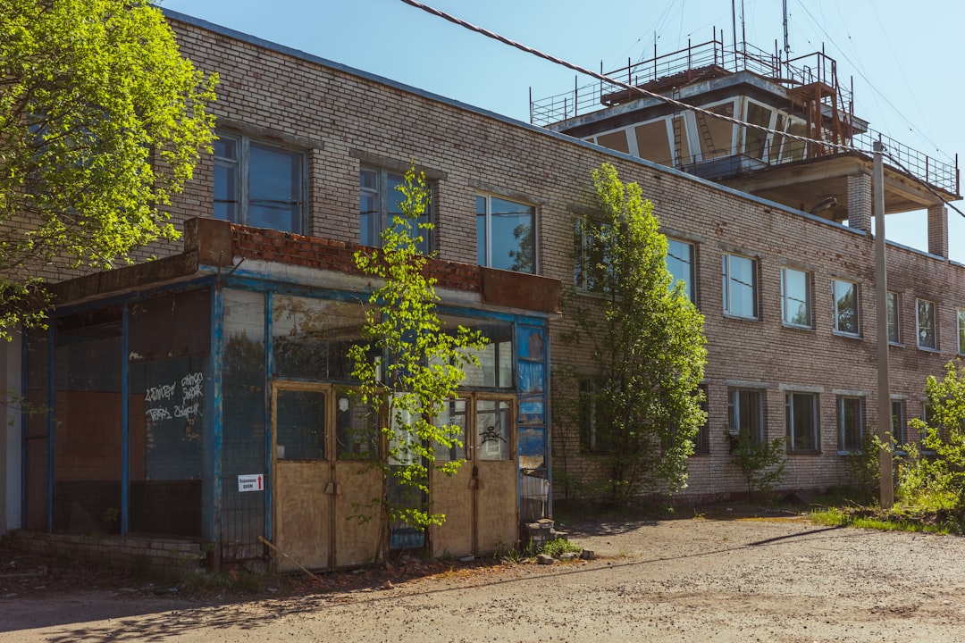 a run down building with lots of windows,