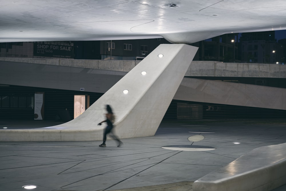 a person riding a skateboard in a large building