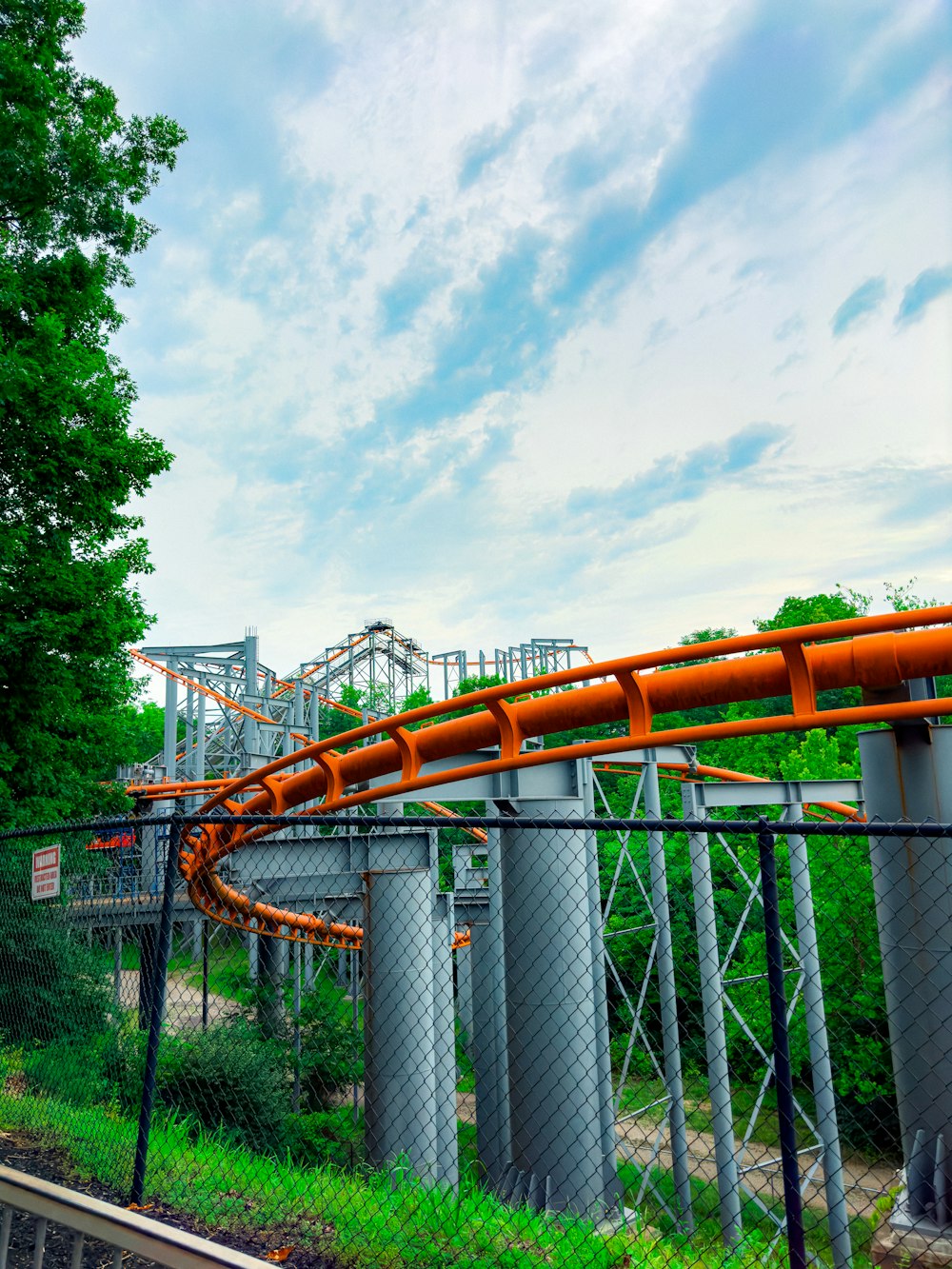 a large orange pipe going over a bridge