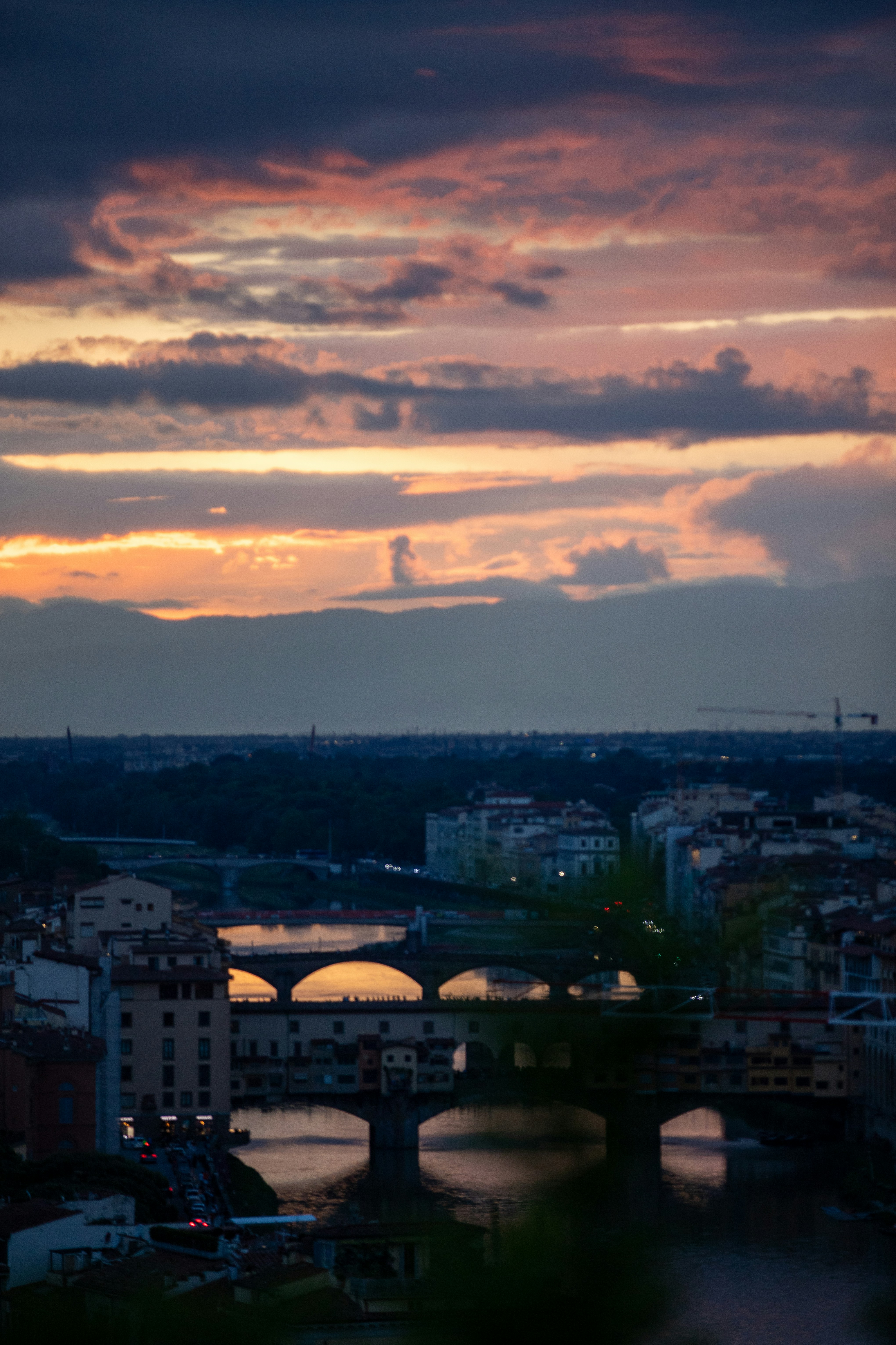 a view of a bridge over a river at sunset