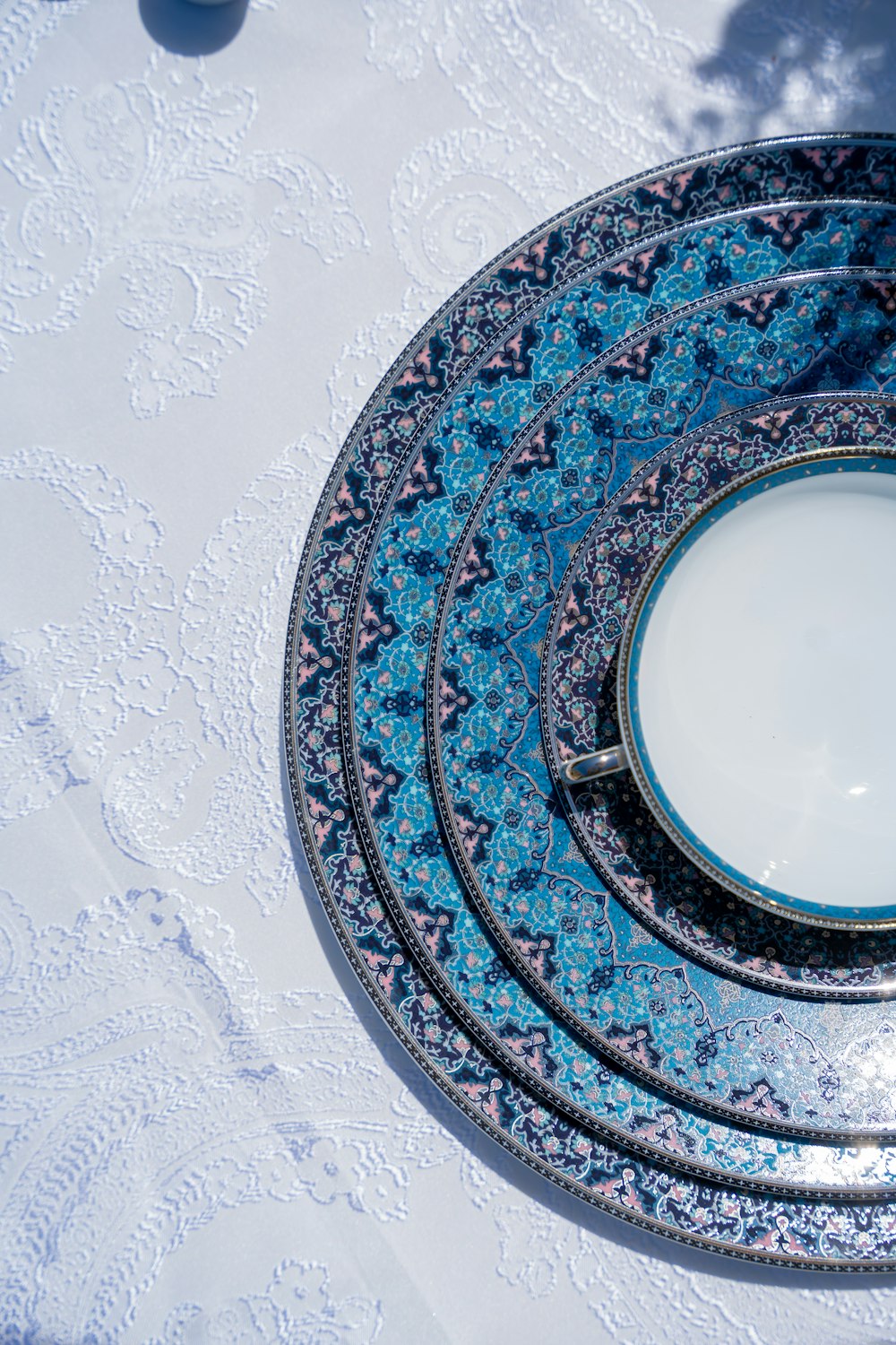 a set of four blue and white plates