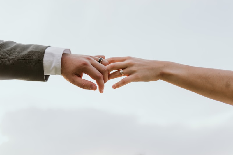 Tender clasp between stylish lovers