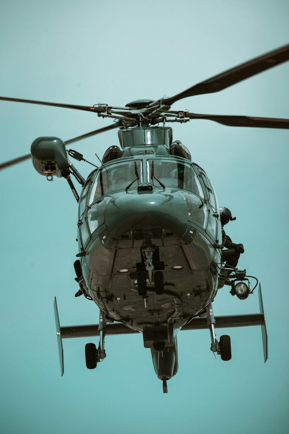 a close up of a helicopter flying in the sky