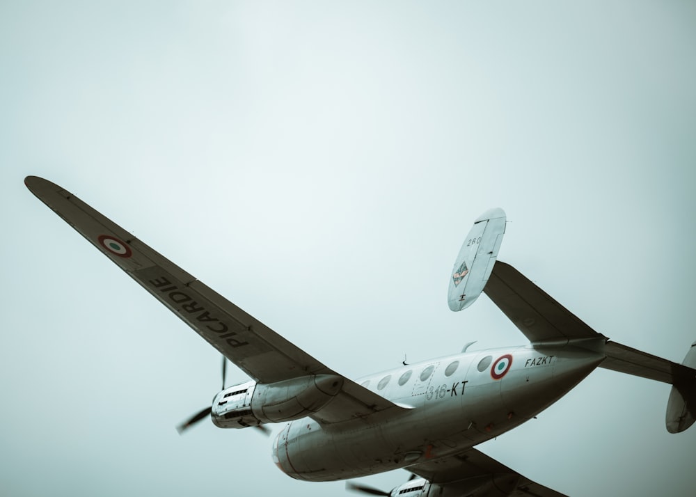 a small propeller plane flying through a cloudy sky