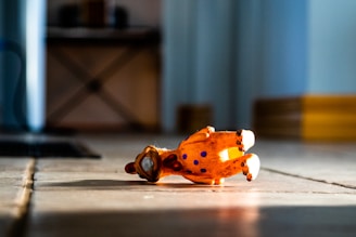 A colorful limited edition contemporary art toy displayed on a wooden shelf with soft natural lighting.