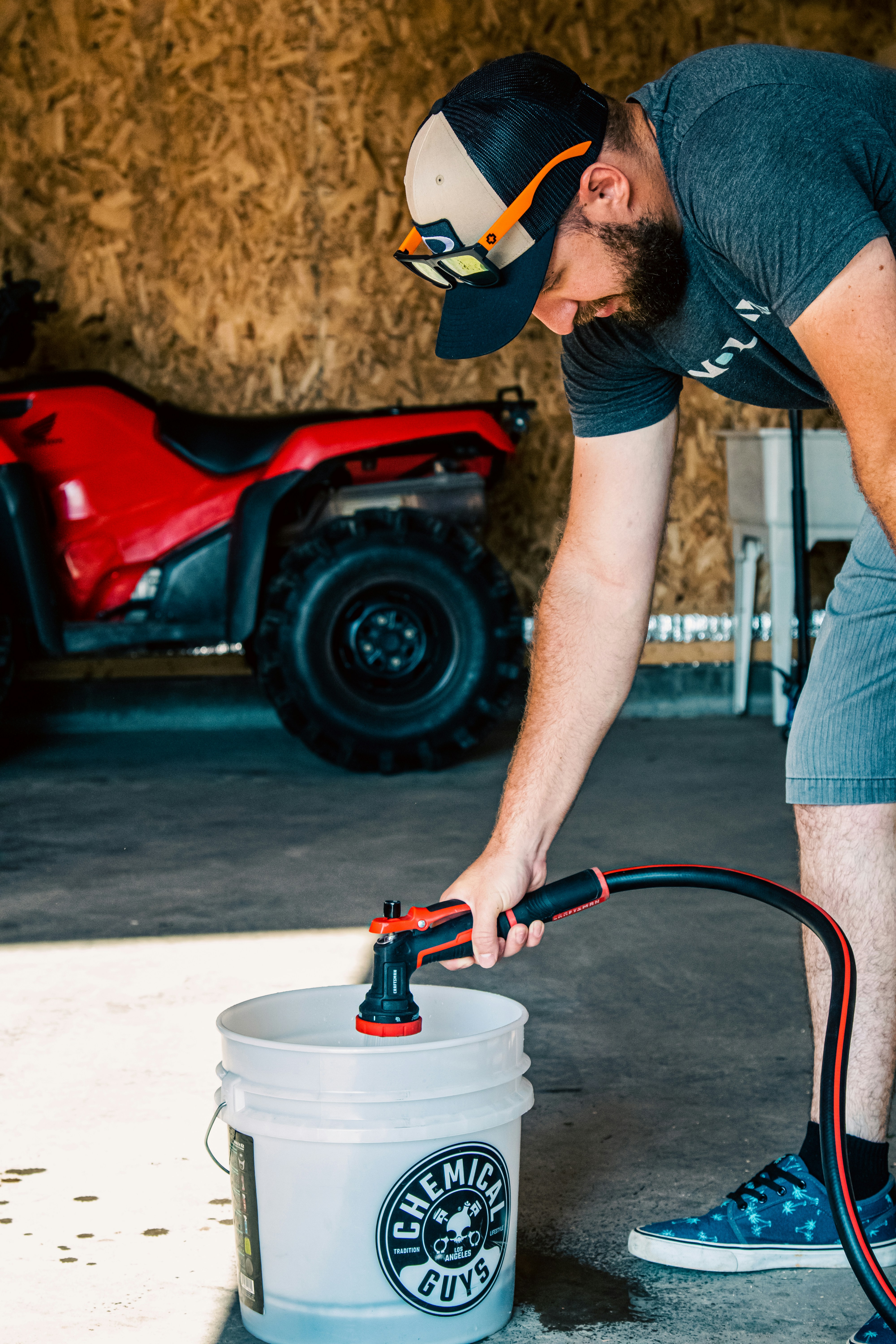 Filling a wash bucket before a two-bucket car wash