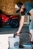 a man is filling a bucket with water
