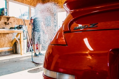 the back end of a red car in a garage