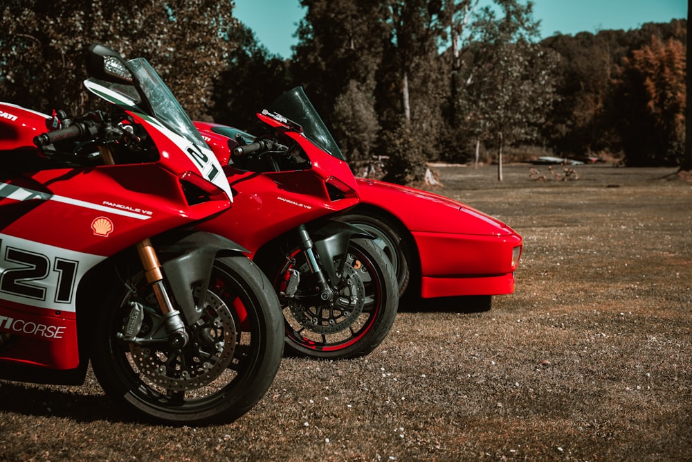 a couple of red motorcycles parked next to each other