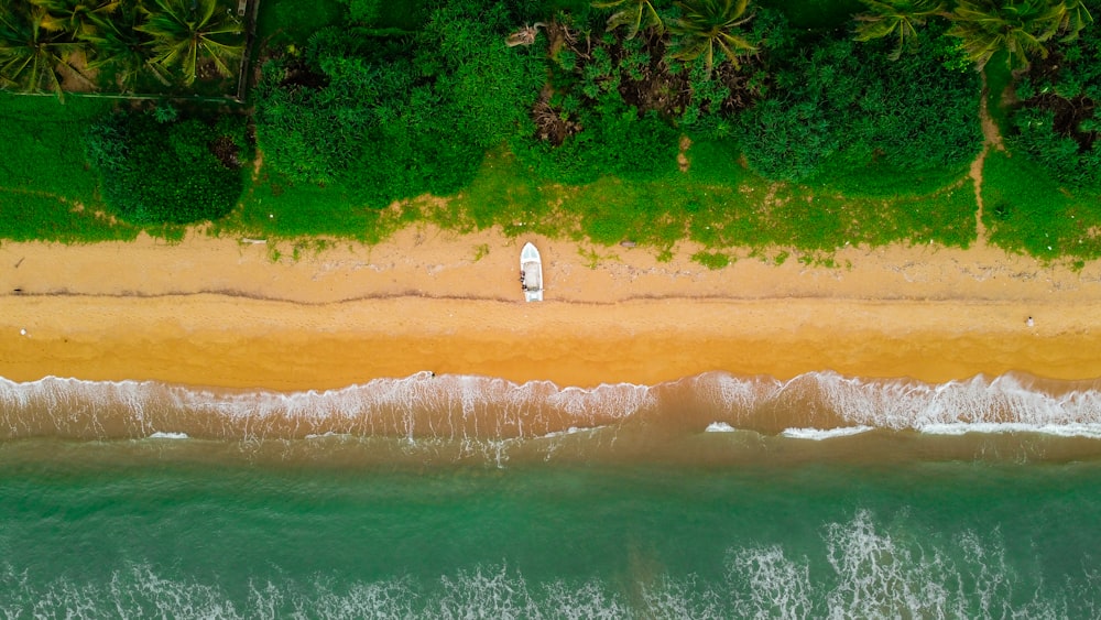 an aerial view of a beach with a surfboard
