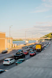 a highway filled with lots of traffic next to a bridge