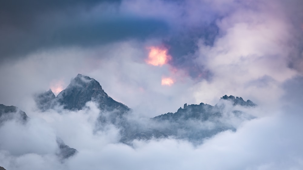 a view of a mountain covered in clouds